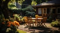 Backyard garden terrace wooden table and chair full of flowers and green with warm light Royalty Free Stock Photo