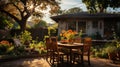 Backyard garden terrace wooden table and chair full of flowers and green with warm light Royalty Free Stock Photo