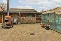 a backyard with a greenhouse and a woodfired furnace