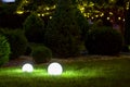 Backyard ground light garden with lantern electric lamp with sphere diffuser.