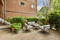 the backyard has a brick patio with chairs and plants Royalty Free Stock Photo