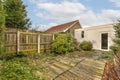 the backyard of a house with a fence and a Royalty Free Stock Photo