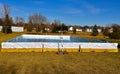 Backyard ice skating rink flooded with water frozen into ice. Royalty Free Stock Photo