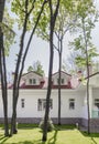 Backyard of modern white country house with brown roof and beautiful garden. Well-groomed beautiful lawn. Space for text Royalty Free Stock Photo