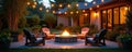 Backyard patio with stone fire pit and Adirondack chairs in evening light. String lights overhead illuminate the cozy seating Royalty Free Stock Photo