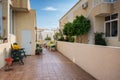 Backyard paved patio with plastic chairs, table and decoration