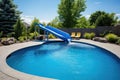 backyard pool with clear water and a slide Royalty Free Stock Photo