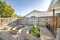 Backyard with raised bed garden and wooden fence and gate Royalty Free Stock Photo