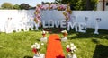 Backyard set up with red carpet and marry me and love signs with rose pedal heart