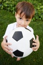 Backyard soccer. A sweet little boy with a soccer ball in the backyard.