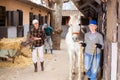 Backyard of the stables on typical autumn day - horse walking and tidying up territory Royalty Free Stock Photo