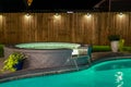 A backyard swimming pool and jacuzzi hot tob at night Royalty Free Stock Photo