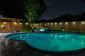 A backyard swimming pool and jacuzzi hot tob at night Royalty Free Stock Photo