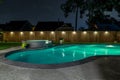 A backyard swimming pool and jacuzzi hot tob at night Royalty Free Stock Photo