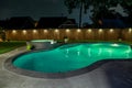 A backyard swimming pool and jacuzzi hot tob at night Royalty Free Stock Photo