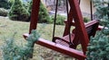 A backyard swing is ideal for relaxing. Garden old wooden swing in the backyard of a rural house Royalty Free Stock Photo