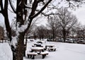 The backyard view of Madison College Truax Campus with its tables and chairs covered by snow in winter