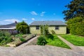 Backyard view of two family house with vegetable beds.