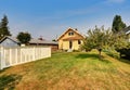 Backyard view of yellow siding craftsman house. Royalty Free Stock Photo