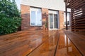 Backyard wooden deck floor boards with fresh brown stain