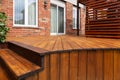 Backyard wooden deck floor boards with fresh brown stain Royalty Free Stock Photo