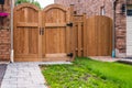 Front of a house with wooden gate. Backyard with wooden new gates. Gate, fence, home entrance Royalty Free Stock Photo