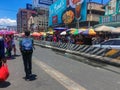 The road side of a national road of transport hub in Metro Manila crowded by people selling various items to form a flea market.