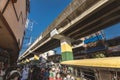 Baclaran, Paranaque, Metro Manila, Philippines - LRT-1, an elevated train line looms over a busy street in Baclaran