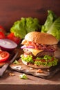 Bacon cheese burger with beef patty tomato onion Royalty Free Stock Photo