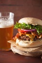 Bacon cheese burger with beef patty tomato onion beer Royalty Free Stock Photo