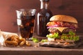 Bacon cheese burger with beef patty tomato onion cola Royalty Free Stock Photo