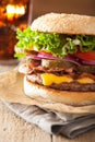 Bacon cheese burger with pickles tomato onion Royalty Free Stock Photo