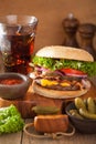 Bacon cheese burger with pickles tomato onion Royalty Free Stock Photo