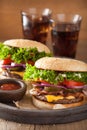 Bacon cheese burger with pickles tomato onion Royalty Free Stock Photo