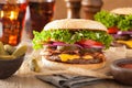 Bacon cheese burger with pickles tomato onion Royalty Free Stock Photo