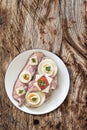 Bacon And Egg Sandwich With An Extra Belly Bacon Rasher On White Porcelain Plate Set On Old Rustic Rough Pinewood Picnic Table Royalty Free Stock Photo