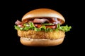 Bacon cheese Bacon cheeseburger hamburger isolated on black. BBQ sauce and lettuce. Royalty Free Stock Photo