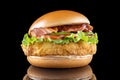 Bacon cheeseburger hamburger isolated on black. BBQ sauce and lettuce. Royalty Free Stock Photo