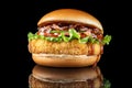 Bacon cheeseburger hamburger isolated on black. BBQ sauce and lettuce. Beautiful black mirror background. Royalty Free Stock Photo