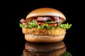 Bacon cheeseburger hamburger isolated on black. BBQ sauce and lettuce. Royalty Free Stock Photo