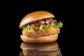Bacon cheeseburger hamburger isolated on black. BBQ sauce and lettuce. Side view Royalty Free Stock Photo