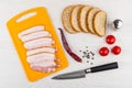 Bacon on cutting board, knife, tomatoes cherry, pepper, bread Royalty Free Stock Photo