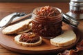 Bacon jam in a small glass jar with toast