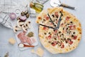 Bacon and mushroom pizza on a table next to raw ingredients. Top view. Royalty Free Stock Photo