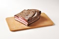 Bacon with pepper on cutting board Royalty Free Stock Photo