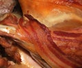 Bacon rasher on cooked bird. Royalty Free Stock Photo