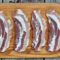 Bacon. Raw steaks on a cutting board Royalty Free Stock Photo