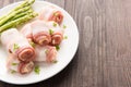 Bacon rolls with asparagus on wooden background Royalty Free Stock Photo