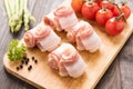 Bacon rolls with tomato, asparagus on wooden background Royalty Free Stock Photo