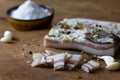 Bacon on wooden Board with spices, garlic, onion, salt.